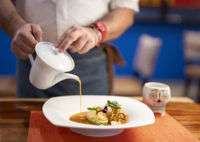 A server pouring tortilla soup tableside